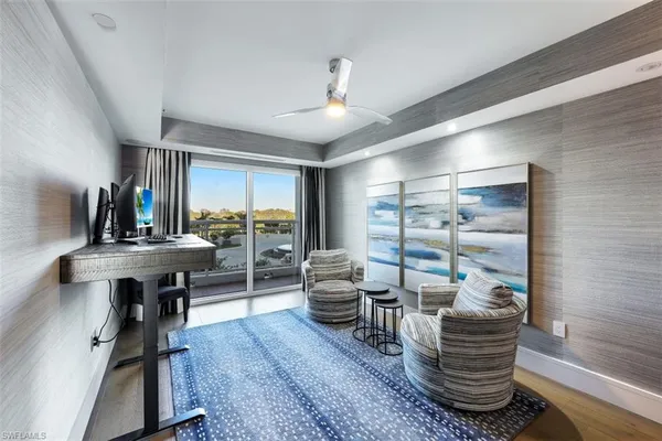 a living room with fireplace furniture and a large window
