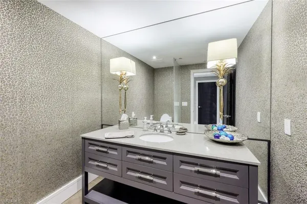 a bathroom with a sink mirror and vanity