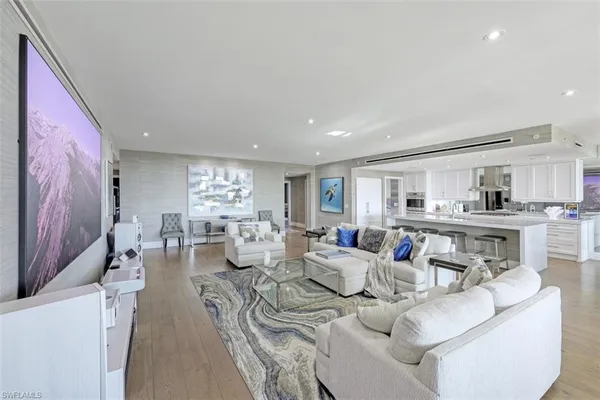 a living room with furniture and view of kitchen