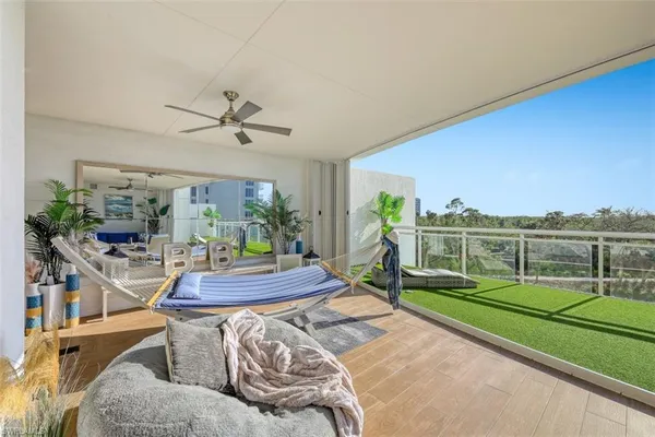 a view of a livingroom with furniture and a floor to ceiling window