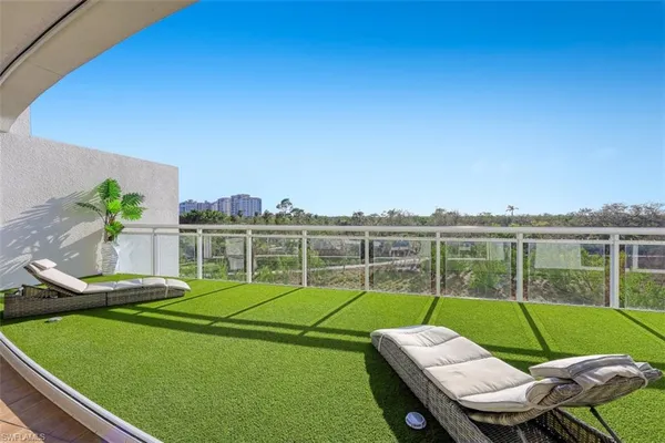 a view of a house with a backyard and a chair