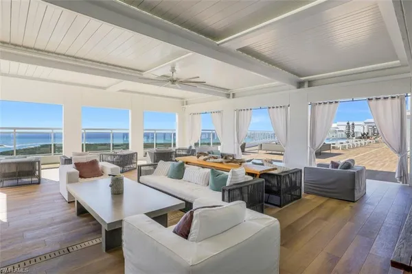 a living room with fireplace furniture and a large window