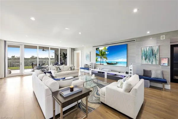 a living room with furniture and a wooden floor