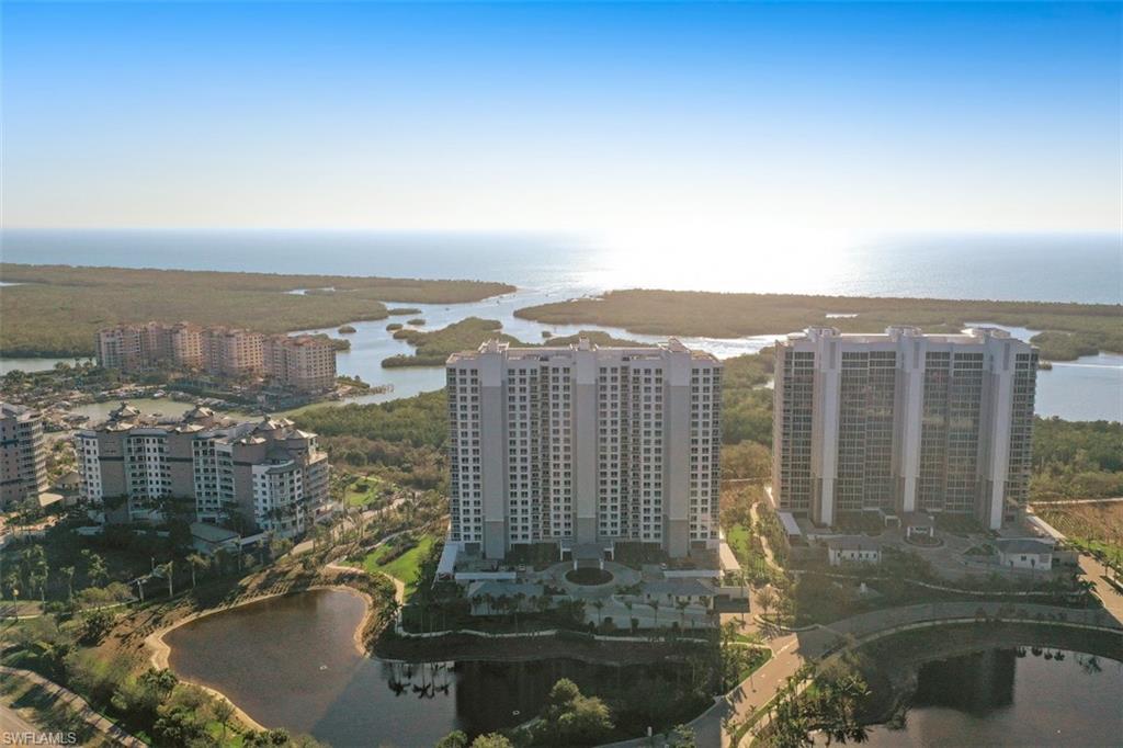 13915 Old Coast Road, Unit 305 Naples, FL 34110 - Photo 32 of 41 a view of a lake with tall building