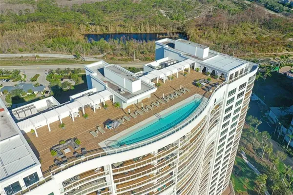 an aerial view of a house with a garden and lake view