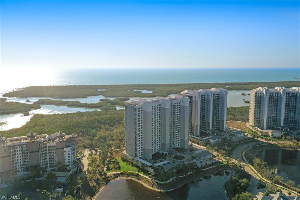 13915 Old Coast Road, Unit 305 Naples, FL 34110 - Photo 40 of 41 a view of a lake with a building in the background