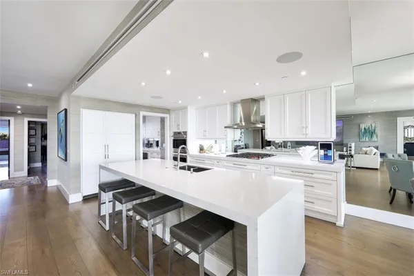 a kitchen with counter and chairs