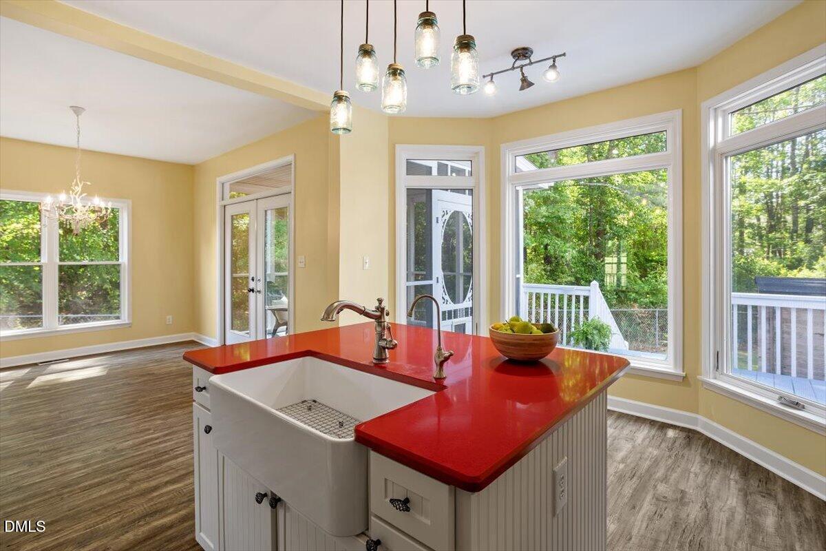 7505 Penny Road Raleigh, NC 27606 - Photo 21 of 35 a view of a dining room with furniture a chandelier and wooden floor