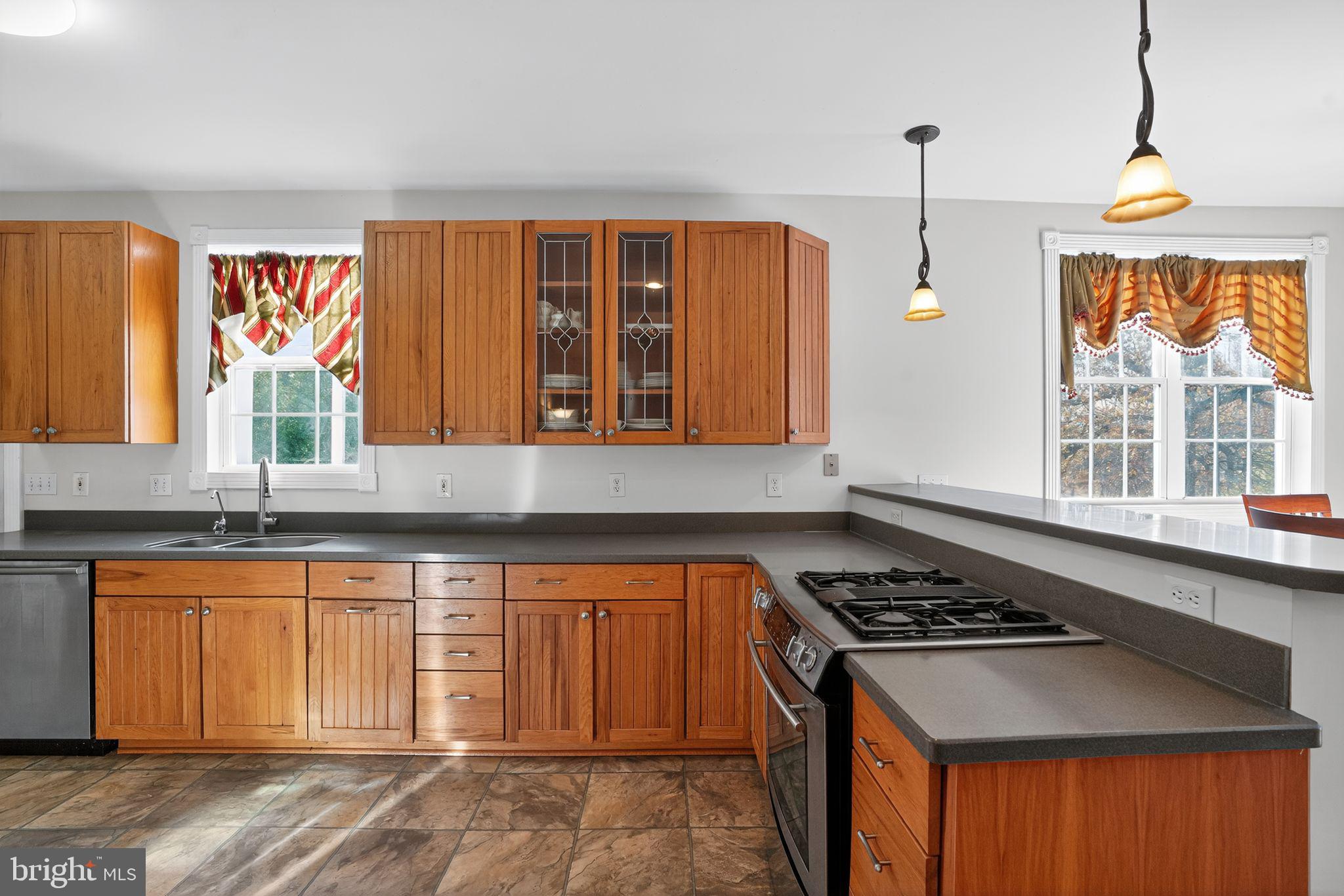 9260 Old Scaggsville Road Laurel, MD 20723 - Photo 13 of 48 a kitchen with stainless steel appliances granite countertop a stove a sink and a refrigerator