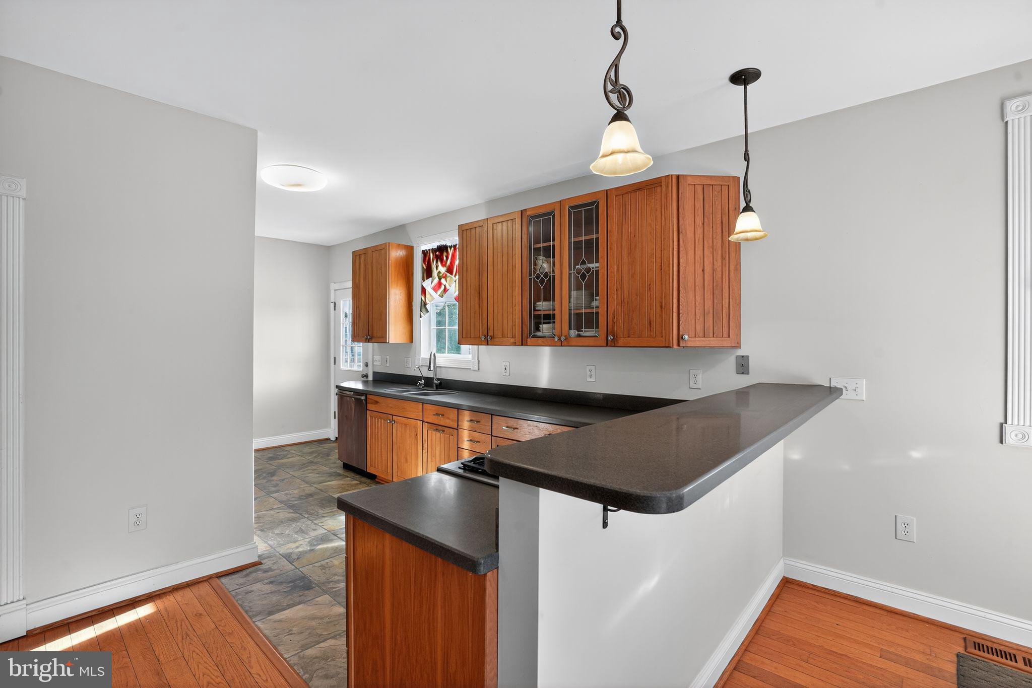 9260 Old Scaggsville Road Laurel, MD 20723 - Photo 14 of 48 a kitchen with stainless steel appliances granite countertop a sink a microwave oven and a counter top space