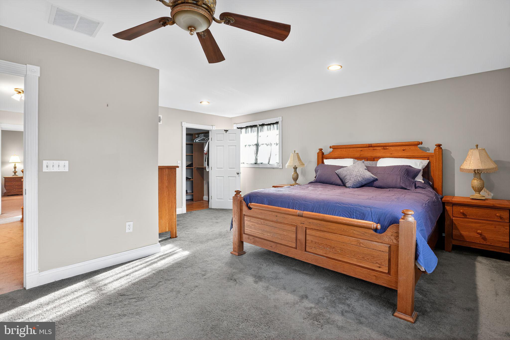 9260 Old Scaggsville Road Laurel, MD 20723 - Photo 20 of 48 a bedroom with a bed and a chandelier