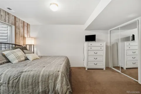 a bedroom with a bed and a television