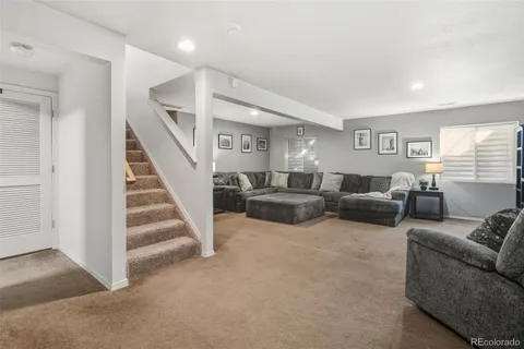 a living room with furniture and a view of bedroom