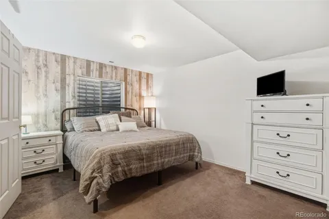 a bedroom with a bed and a television