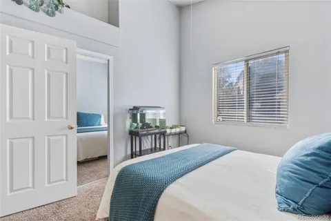 a bedroom with a bed and a table