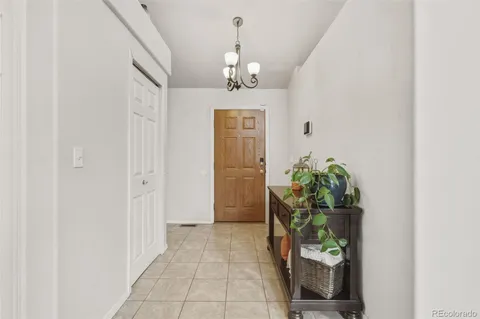 a view of a hallway to dining room and front door