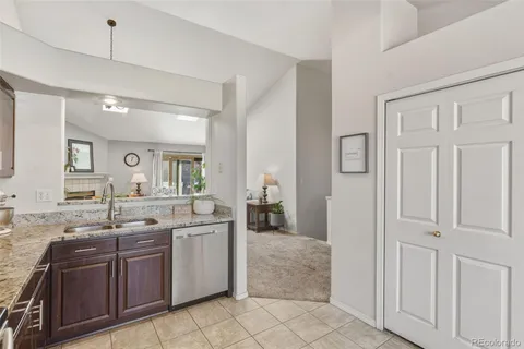 a kitchen with stainless steel appliances granite countertop a sink and cabinets