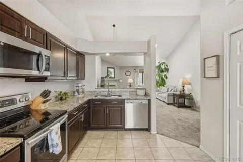 a kitchen with a stove a sink and a microwave