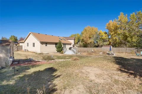 a view of white house with a yard