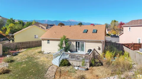 an aerial view of a house with swimming pool and sitting area