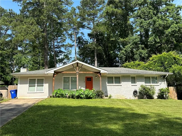 a front view of a house with a garden
