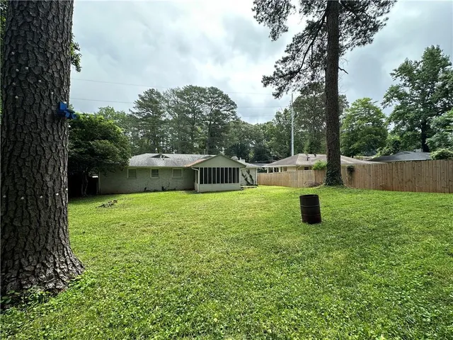a view of a backyard with large trees
