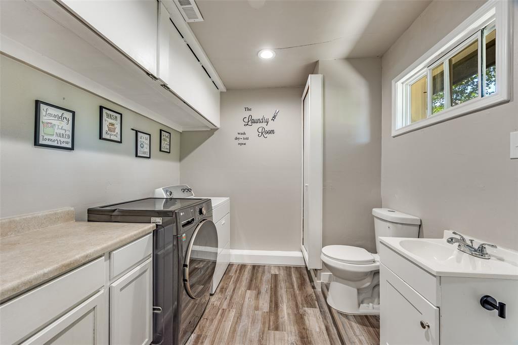 11021 Cactus Lane Dallas, TX 75238 - Photo 20 of 26 a view of a bathroom with a sink and a toilet