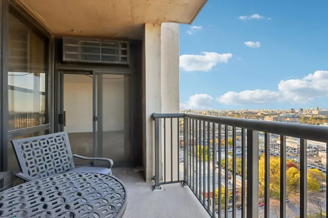 a view of a balcony with furniture