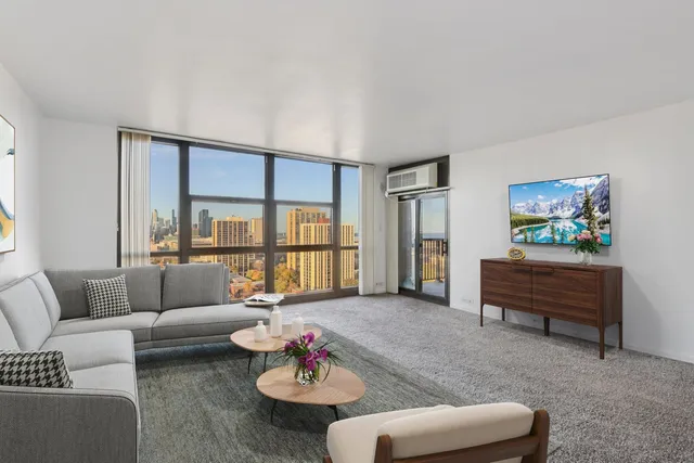 a living room with furniture and a floor to ceiling window
