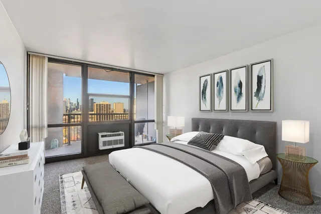 a bedroom with a large bed and a flat tv screen