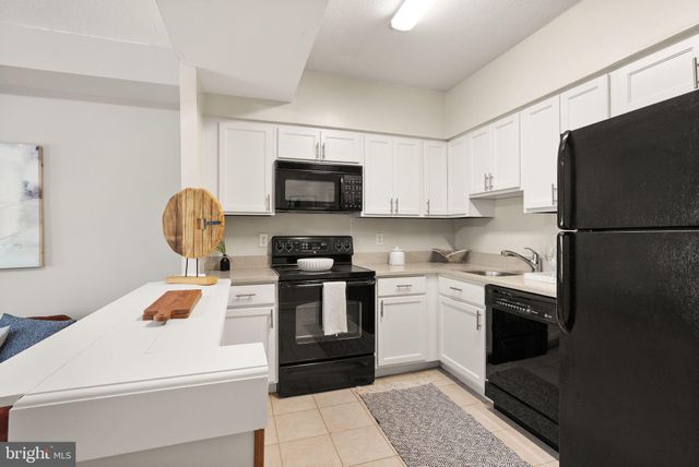a kitchen with a sink appliances and cabinets