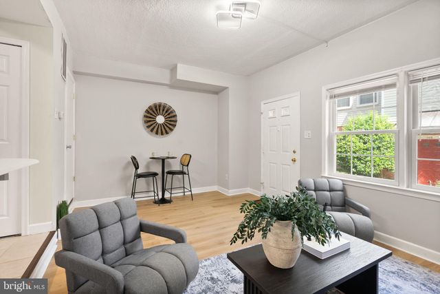 a living room with furniture potted plant and a window