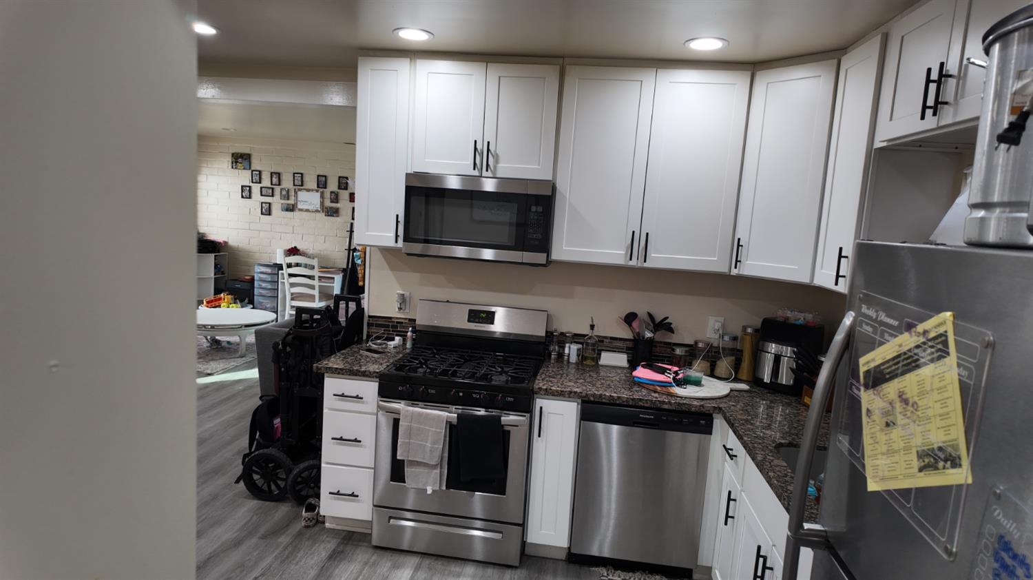 129 Phoenix Avenue Modesto, CA 95354 - Photo 11 of 21 a kitchen with stainless steel appliances granite countertop a stove and a microwave