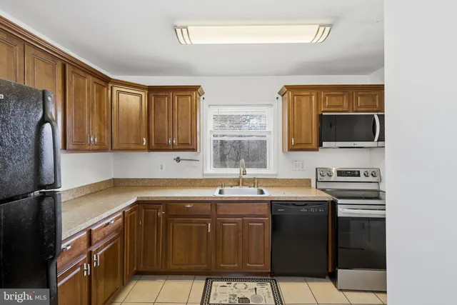 a kitchen with a sink stove and microwave