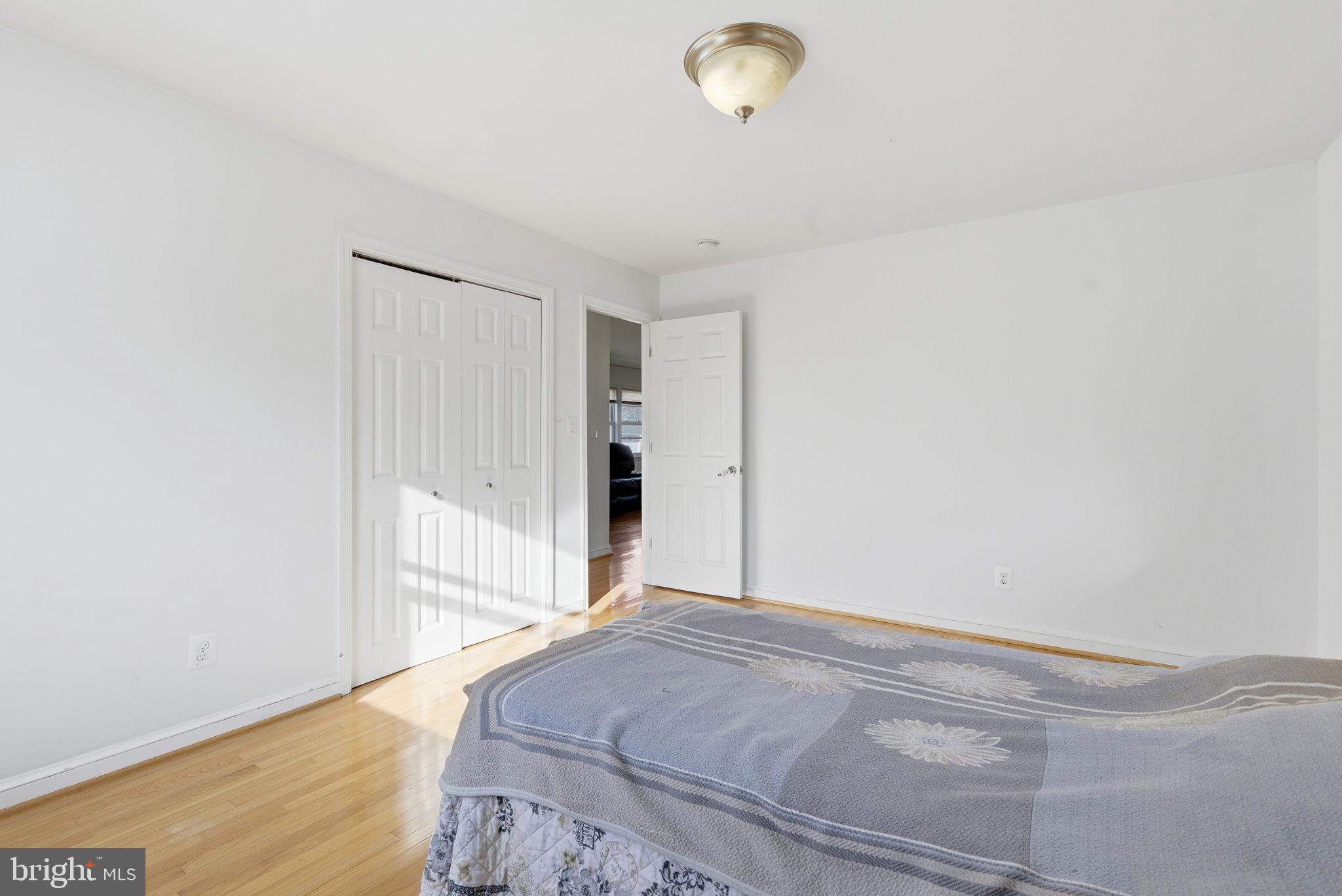 9013 Volta Street Lanham, MD 20706 - Photo 16 of 31 a bedroom with a bed and a chandelier