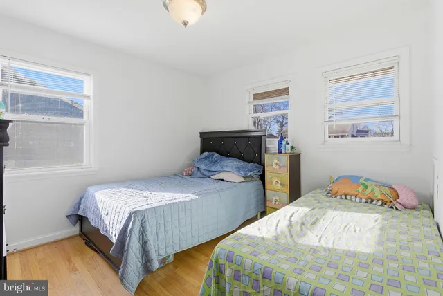 a bedroom with two beds and a window