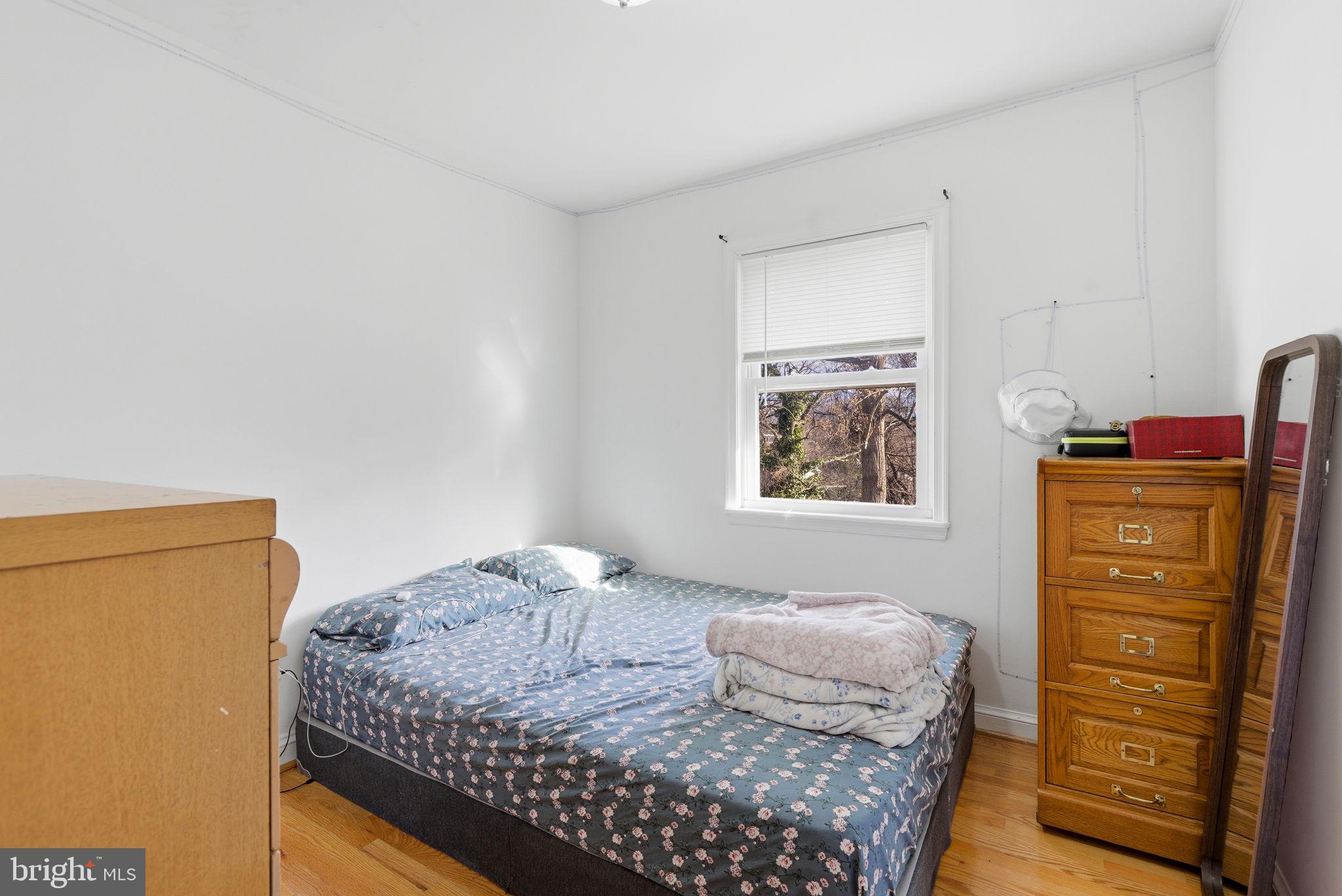 9013 Volta Street Lanham, MD 20706 - Photo 18 of 31 a bedroom with a bed and furniture