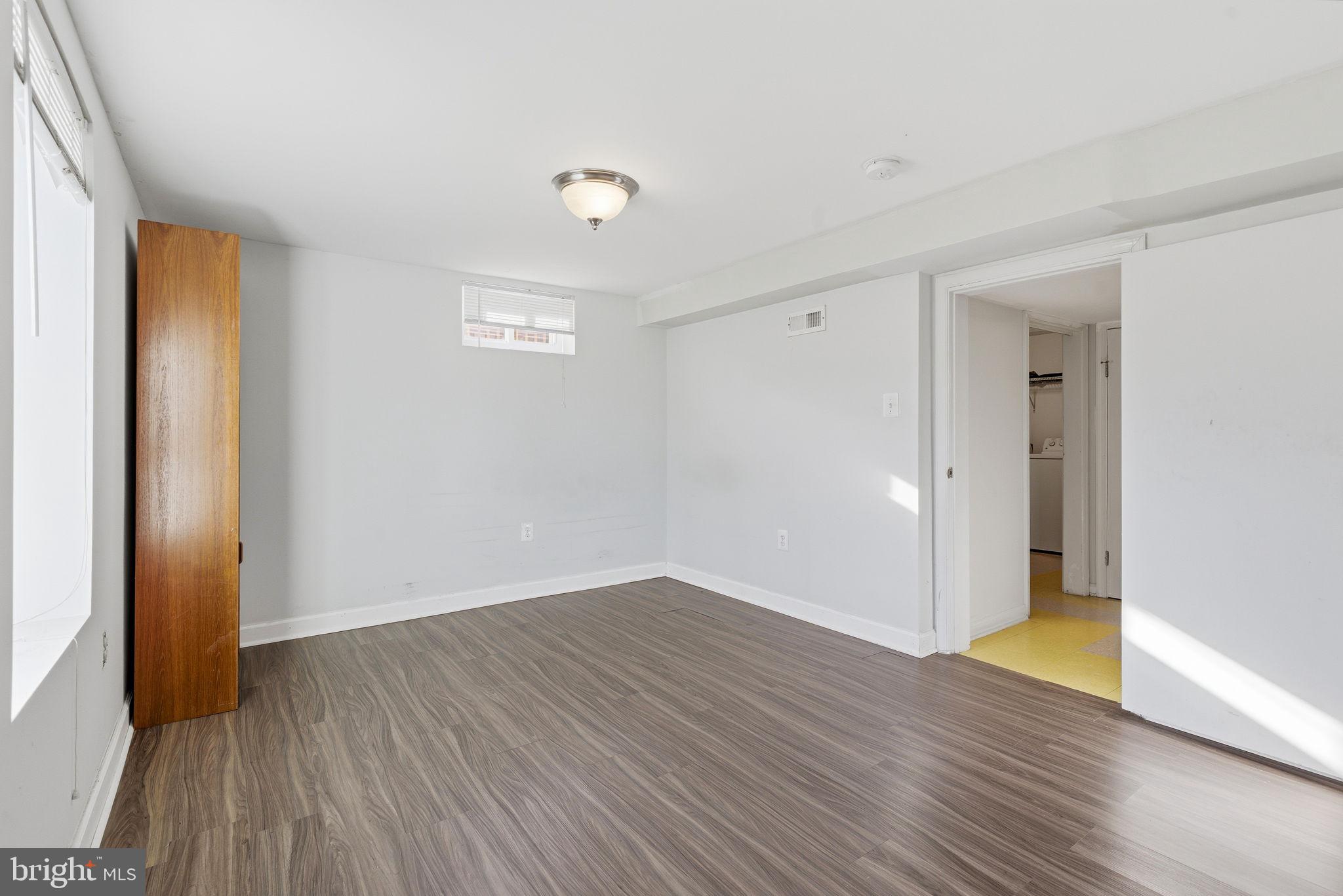 9013 Volta Street Lanham, MD 20706 - Photo 25 of 31 an empty room with wooden floor and windows