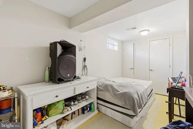 a bedroom with a bed and a dresser in it