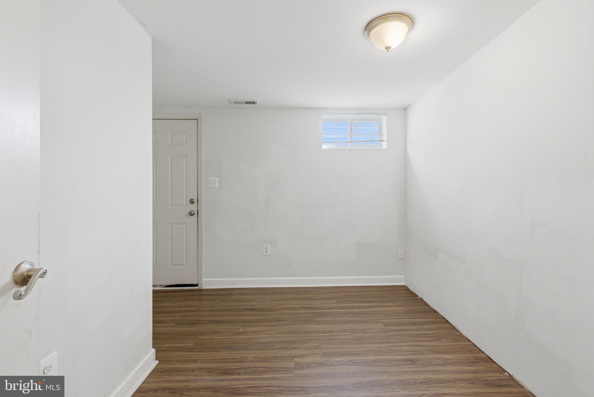 9013 Volta Street Lanham, MD 20706 - Photo 27 of 31 a view of room with wooden floor