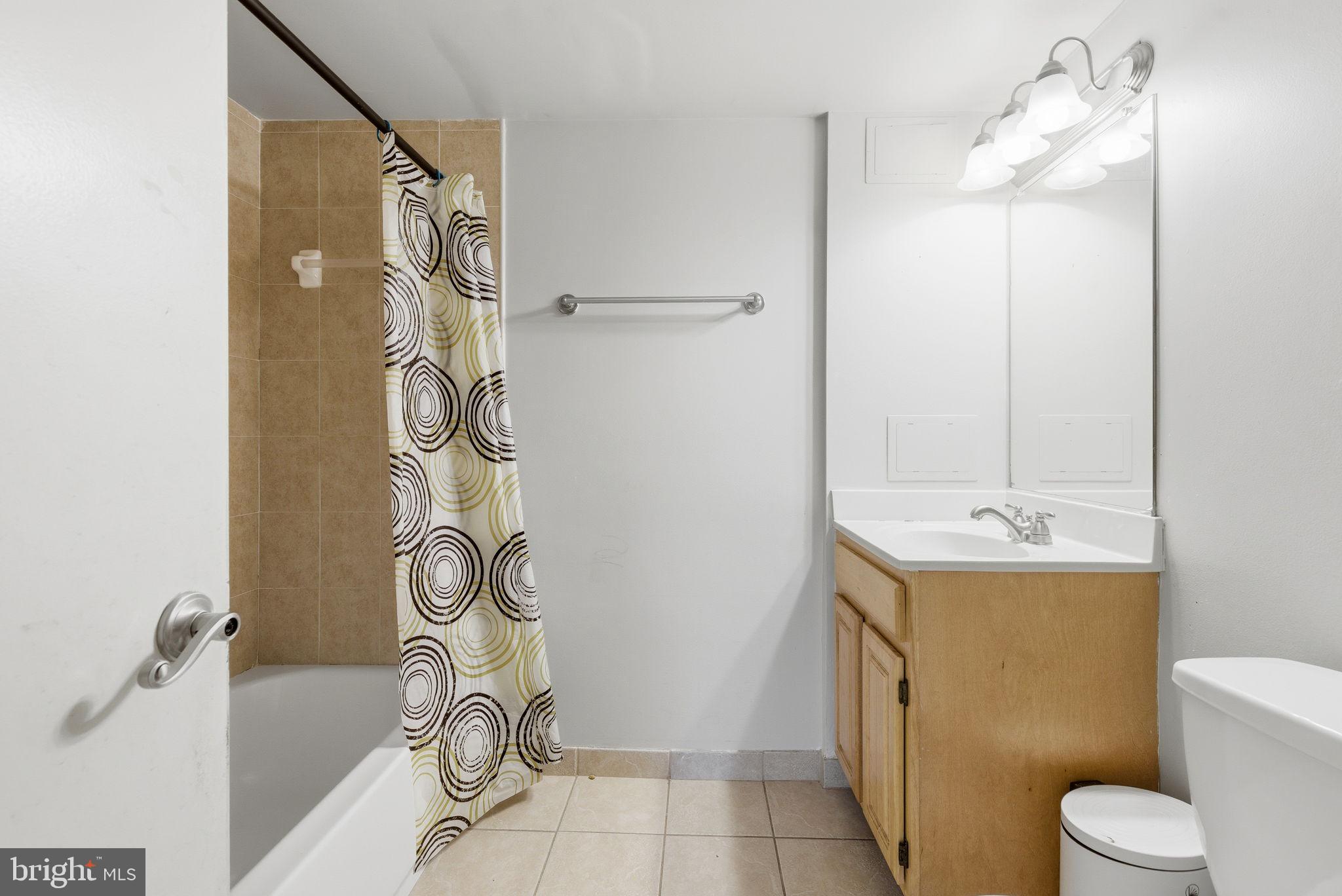 9013 Volta Street Lanham, MD 20706 - Photo 28 of 31 a bathroom with a granite countertop sink and a mirror