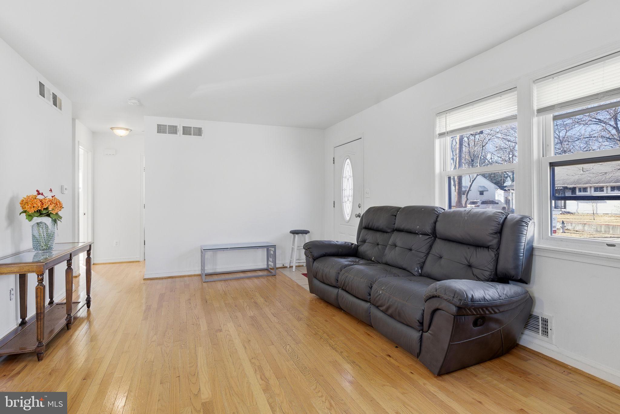9013 Volta Street Lanham, MD 20706 - Photo 7 of 31 a living room with furniture and a wooden floor