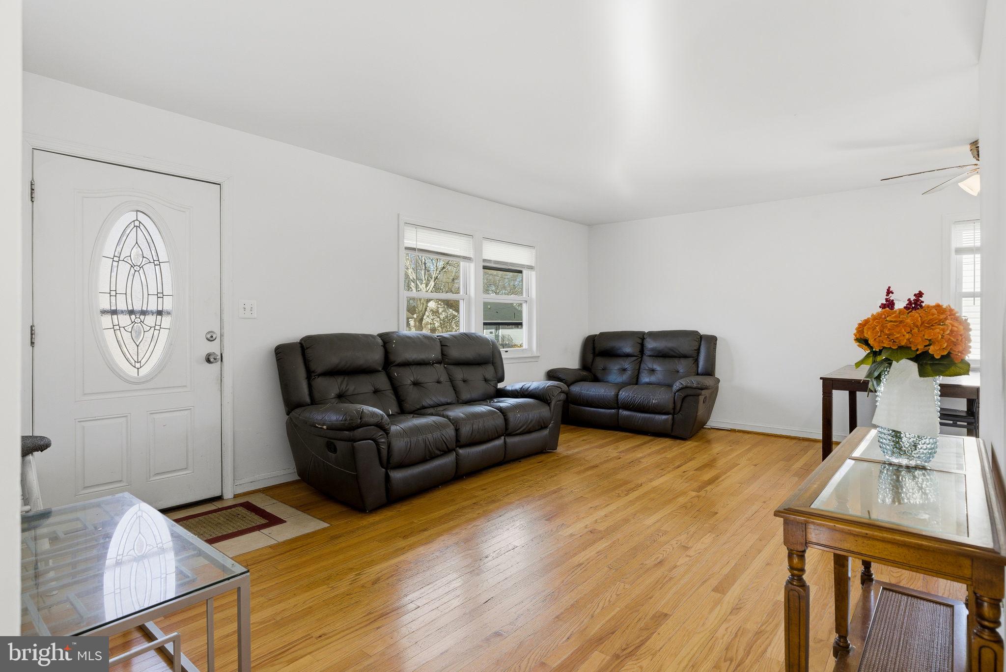 9013 Volta Street Lanham, MD 20706 - Photo 9 of 31 a living room with furniture and a chandelier