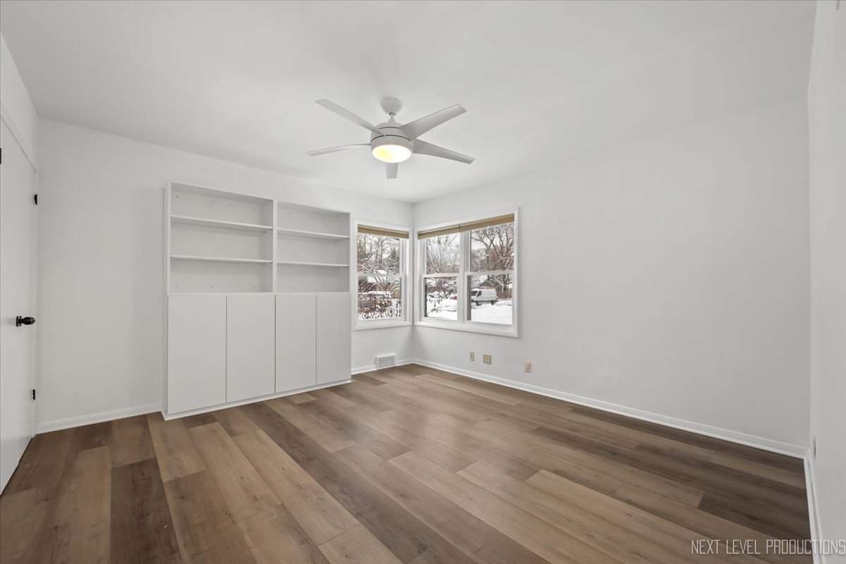 1017 South 6th Street St. Charles, IL 60174 - Photo 12 of 30 a view of empty room with wooden floor and fan