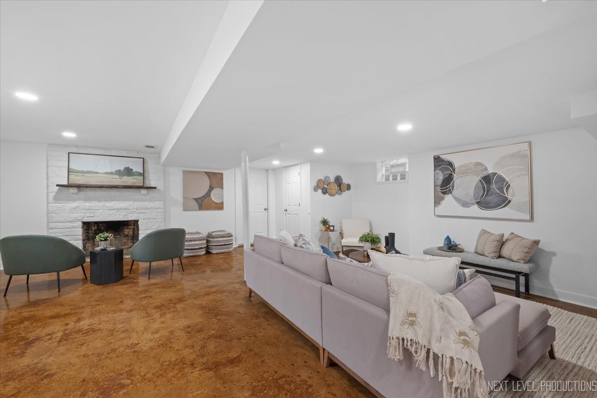 1017 South 6th Street St. Charles, IL 60174 - Photo 21 of 30 a living room with furniture a fireplace and a table