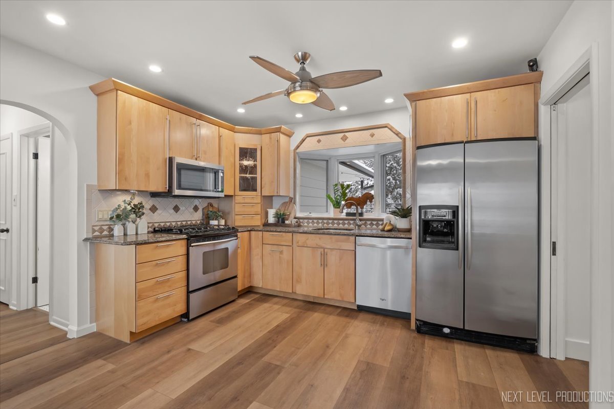 1017 South 6th Street St. Charles, IL 60174 - Photo 6 of 30 a kitchen with stainless steel appliances granite countertop a refrigerator a stove top oven a sink and dishwasher