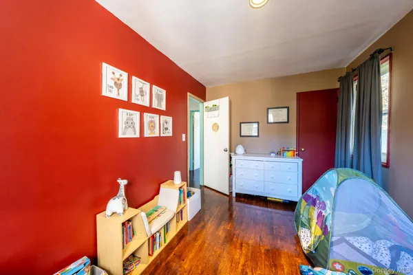 a bedroom with furniture and wooden floor