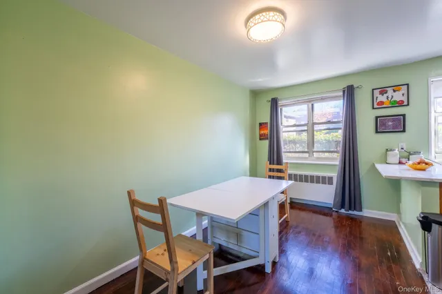 a view of a dining room with furniture a chandelier and wooden floor