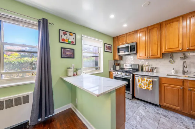 a kitchen with stainless steel appliances granite countertop wooden cabinets a sink and a stove