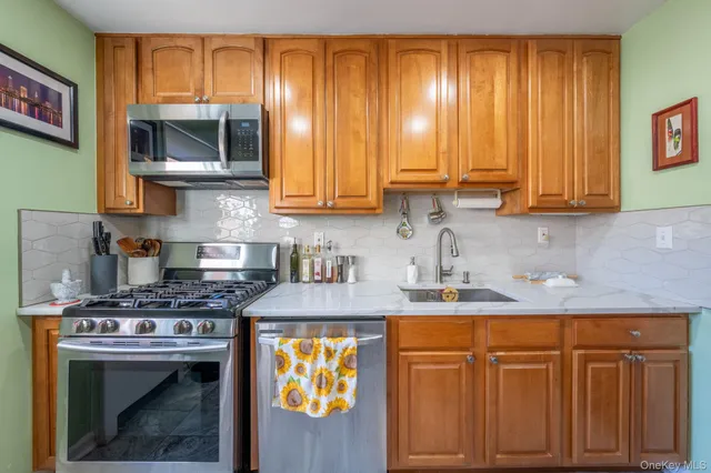 a kitchen with stainless steel appliances granite countertop a sink stove and cabinets